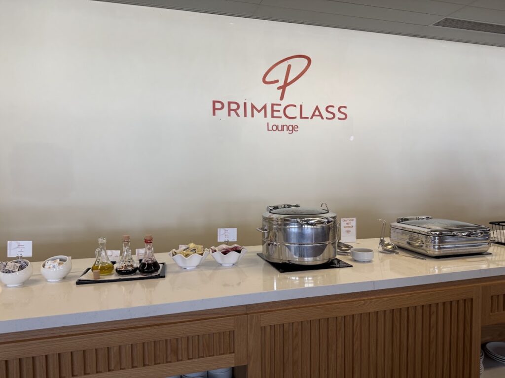 PrimeClass Lounge buffet counter with beverages and food