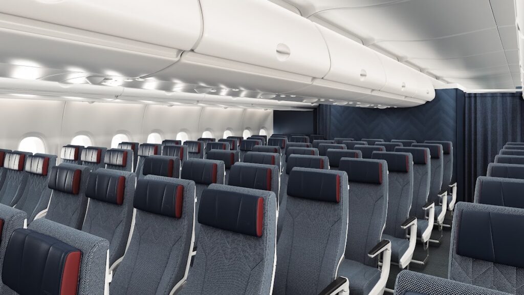 Economy cabin with red-accented seats and privacy dividers