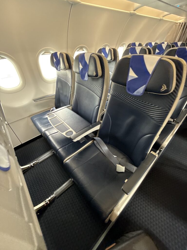 Aegean Airlines business class cabin with blue seats and windows