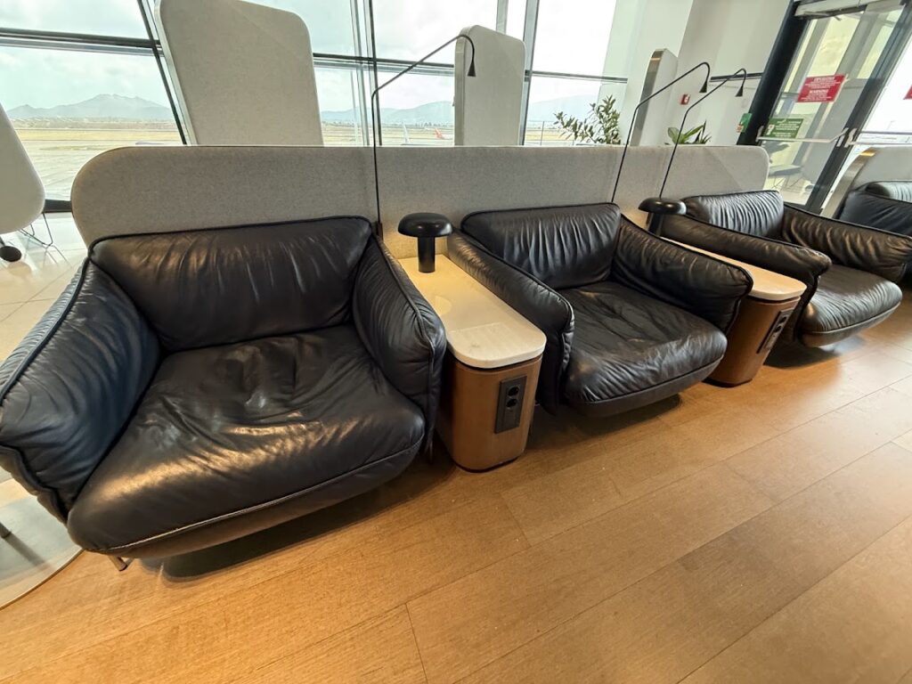 Heathrow lounge seating with airfield runway views