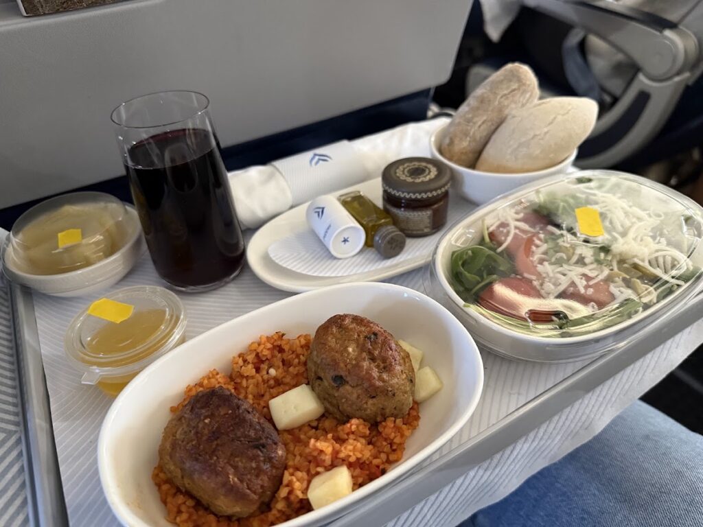 Aegean Airlines business class meal with meatballs and salad